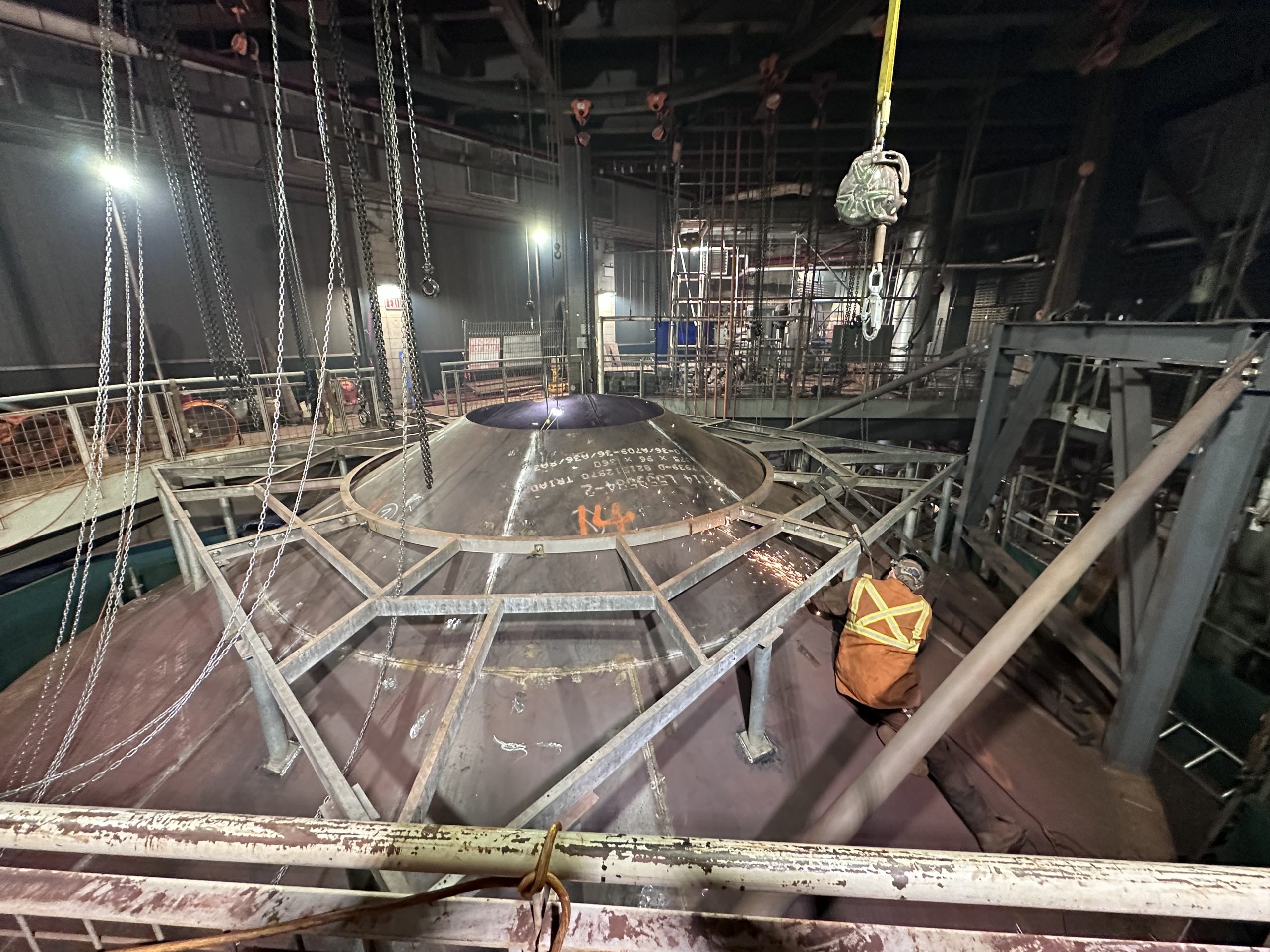 Steel beams are arranged in a factory setting, showcasing engineering and industrial design.