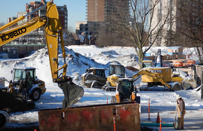 A bulldozer operates in a snowy landscape, showcasing heavy machinery in winter conditions.