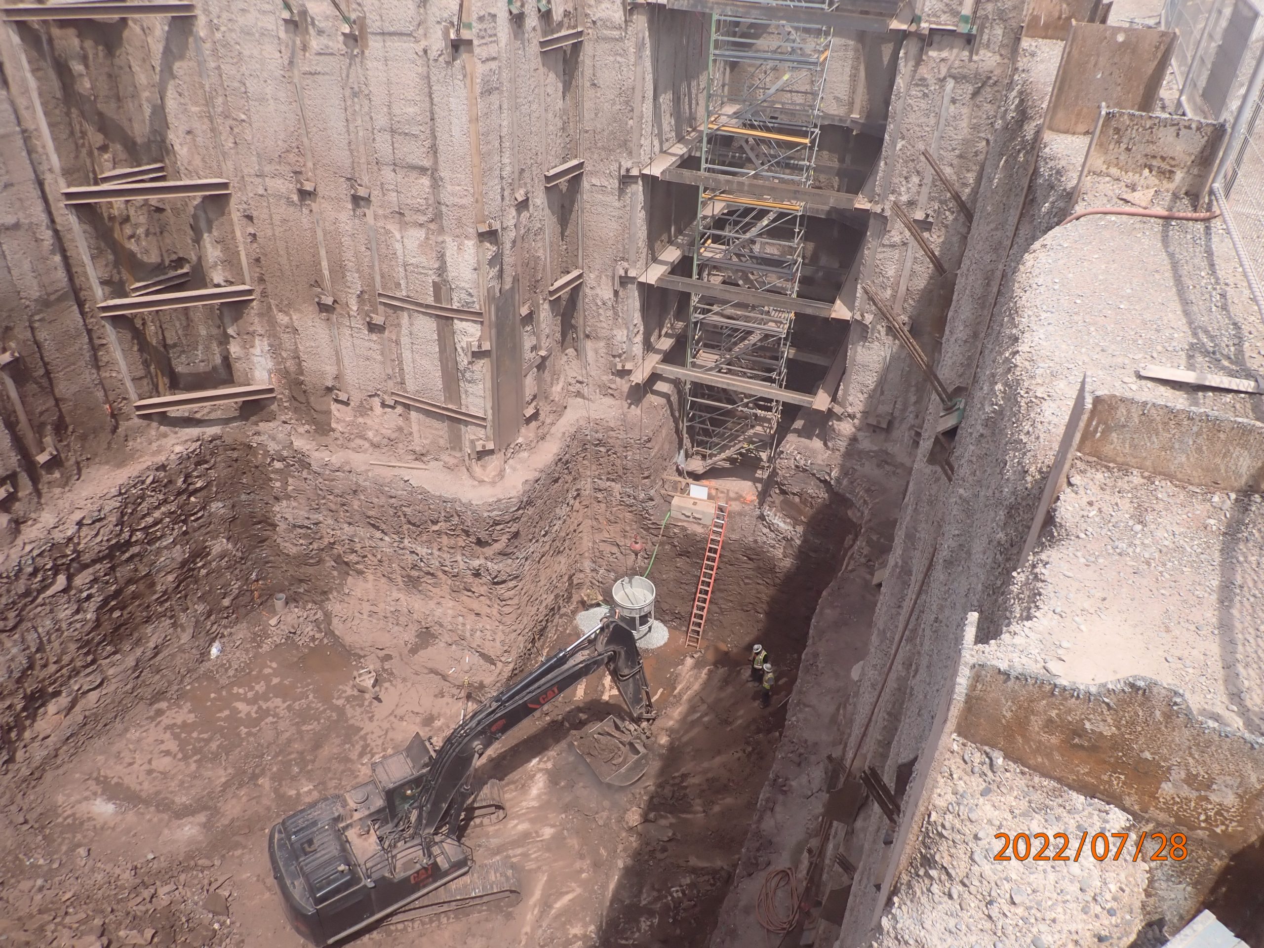 A construction site featuring CAT machinery and materials.